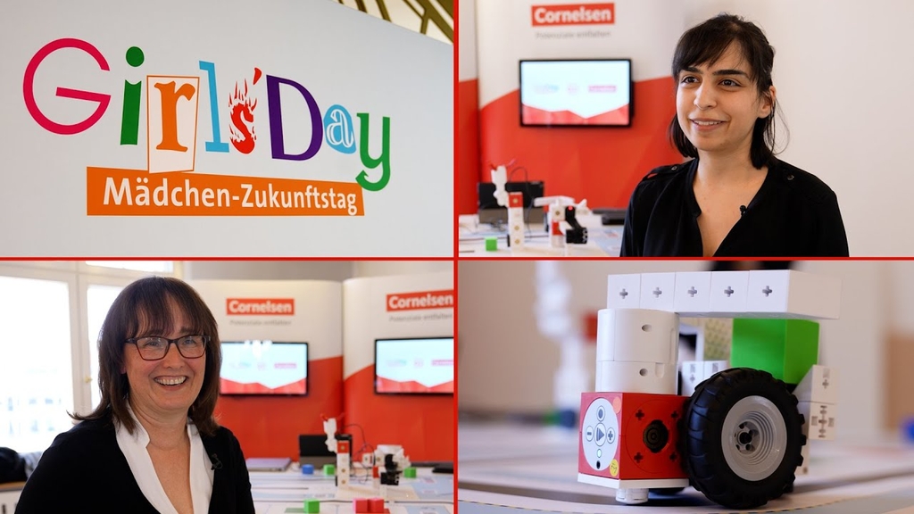 Das Bild zeigt eine Veranstaltung unter dem Motto "Girls' Day - Mädchen-Zukunftstag", bei dem Mädchen ermutigt werden, technische und naturwissenschaftliche Berufe zu erkunden. Im Hintergrund sind interaktive Lernstationen und Modelle zu sehen, die auf ex