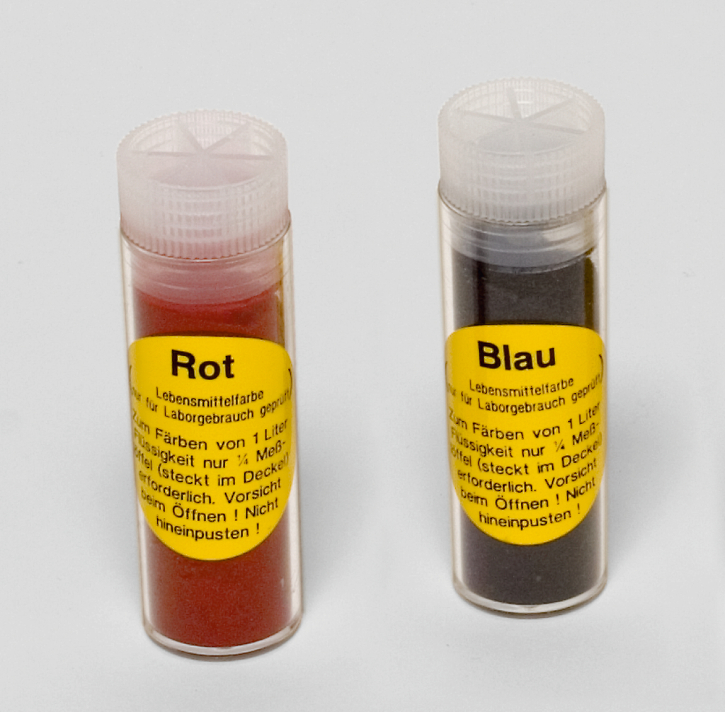 Das Bild zeigt zwei Röhrchen mit Lebensmittelfarben, eine rote und eine blaue. Beide Röhrchen sind beschriftet und weisen darauf hin, dass die Farben für Laborgebrauch geeignet sind und spezifische Anweisungen zur Verwendung enthalten.