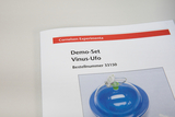Das Bild zeigt eine Produktseite für ein Demo-Set namens "Vinus-Ufo" aus dem Online-Shop von Cornelsen Experimenta. Es enthält die Bestellnummer 33150 und zeigt eine Abbildung des Experimentierkits mit einer blauen Kuppel.