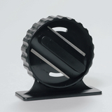 Das Bild zeigt ein schwarzes Experimentiergerät mit einer runden Form und einer strukturierten Griffkante. Es steht stabil auf einer kleinen Basis und hat zwei parallele Schlitze, die für verschiedene wissenschaftliche Anwendungen genutzt werden können.