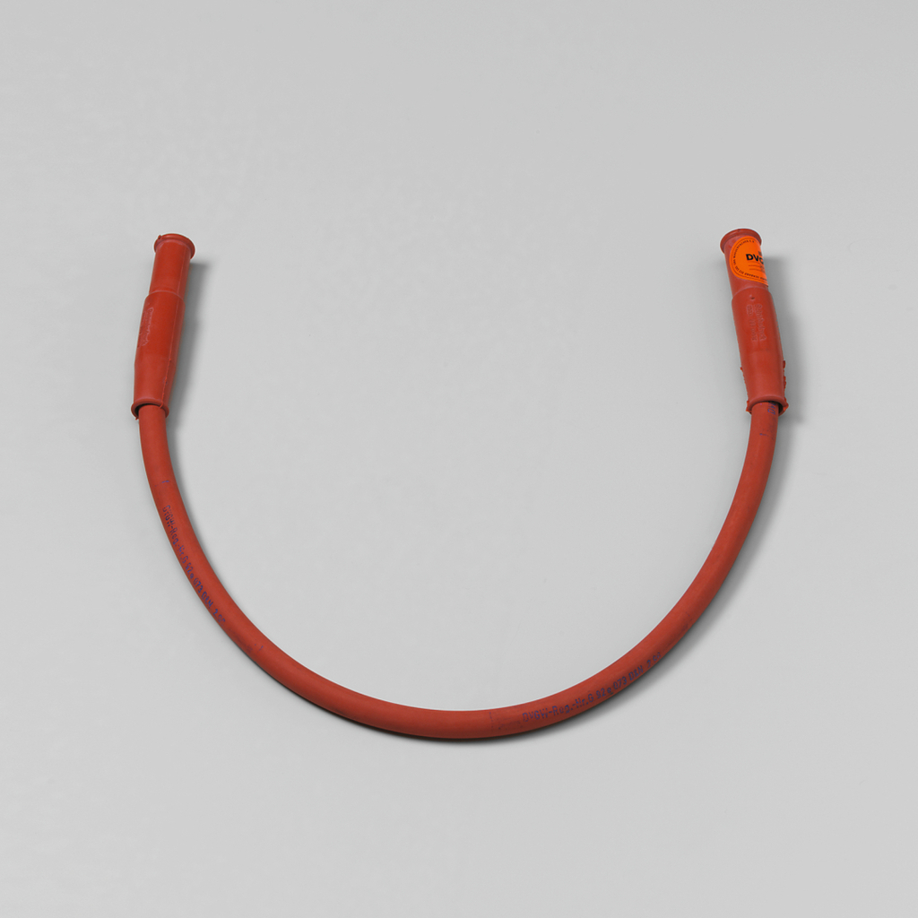 Das Bild zeigt einen roten flexiblen Schlauch mit zwei Griffen an den Enden. Dieser Schlauch ist wahrscheinlich für experimentelle Anwendungen im Bildungsbereich gedacht.