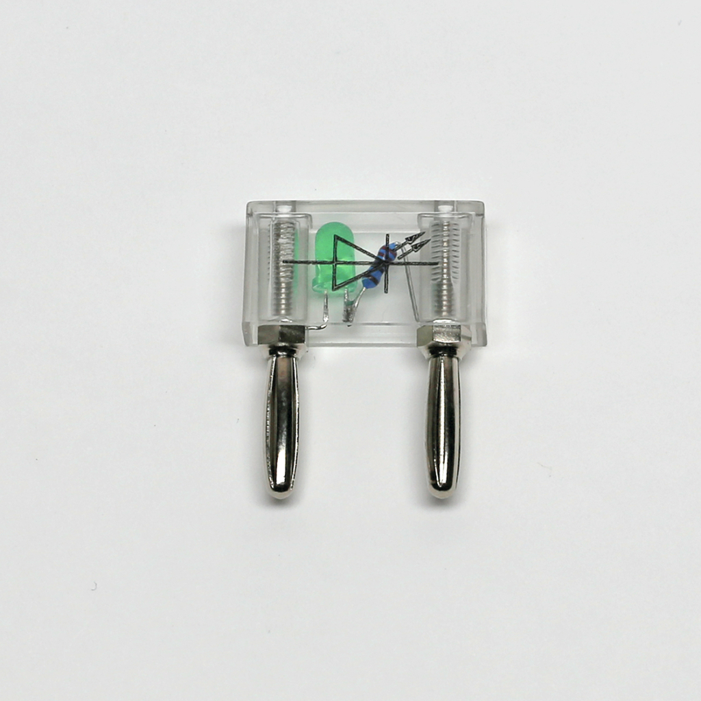 Das Bild zeigt ein transparentes elektrisches Experimentiergerät mit zwei Metallanschlüssen. Im Inneren sind eine grüne LED, ein Widerstand und eine Diode sichtbar, die typischerweise für Bildungszwecke verwendet werden.