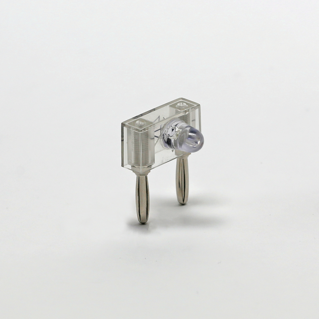 Das Bild zeigt ein transparentes elektronisches Bauteil mit einer LED und zwei Metallanschlüssen. Es wird vermutlich für experimentelle Zwecke im Bildungsbereich verwendet, um elektrische Schaltungen zu demonstrieren.