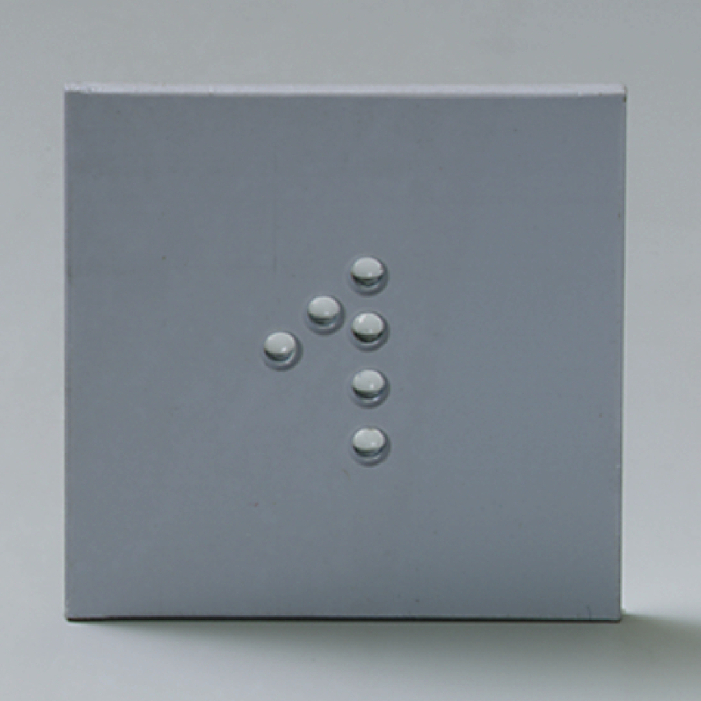 Das Bild zeigt eine graue Fläche mit mehreren kleinen, runden Objekten, die in einer bestimmten Anordnung platziert sind. Diese Objekte könnten Bestandteil eines Experimentierkits für den Bildungsbereich sein, möglicherweise zur Untersuchung physikalischer Phänomene.