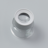 Das Bild zeigt eine Lupe mit einem klaren Kunststoffgehäuse und einer runden Linse. Diese Lupe eignet sich für Experimentierzwecke im Bildungsbereich, um Objekte zu vergrößern und Details zu beobachten.