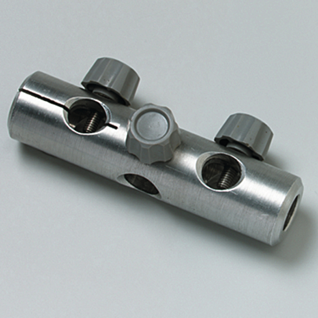 Das Bild zeigt ein metallisches Stabilisierungselement mit mehreren Öffnungen und Schraubmechanismen. Es dient als Verbindungsteil in experimentellen Aufbauten, um verschiedene Komponenten sicher zu fixieren.