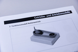 Das Bild zeigt ein Funktionsmodell eines Kettenantriebs, das auf einer Plattform montiert ist. Es wird als Lehrmaterial im Kontext von Getrieben und Antriebssystemen verwendet.