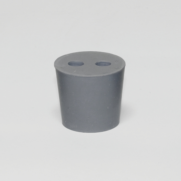 Das Bild zeigt einen grauen, zylindrischen Behälter mit zwei runden Löchern in der Oberseite. Dieser Experimentierbedarf ist wahrscheinlich für den Schulunterricht oder chemische Versuche konzipiert.