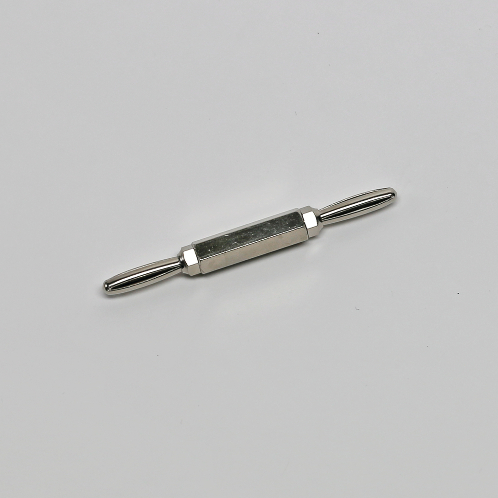 Das Bild zeigt ein metallisches Experimentiergerät mit zwei griffartigen Enden und einem zylindrischen Körper in der Mitte. Es könnte für physikalische oder chemische Experimente im Bildungsbereich verwendet werden.