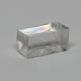 Das Bild zeigt einen klaren, prismatischen Kristall, der durch seine glatte Oberfläche und die Lichtreflexionen besticht. Er eignet sich ideal für Experimente zur Lichtbrechung und zur Untersuchung optischer Phänomene im Bildungsbereich.