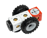 Das Bild zeigt ein Modulsystem für einen kleinen Roboter mit vier Rädern und verschiedenen bunten Bausteinen. Die Bausteine verfügen über Steckverbindungen und Bedienelemente, die für Experimente im Bildungsbereich genutzt werden können.